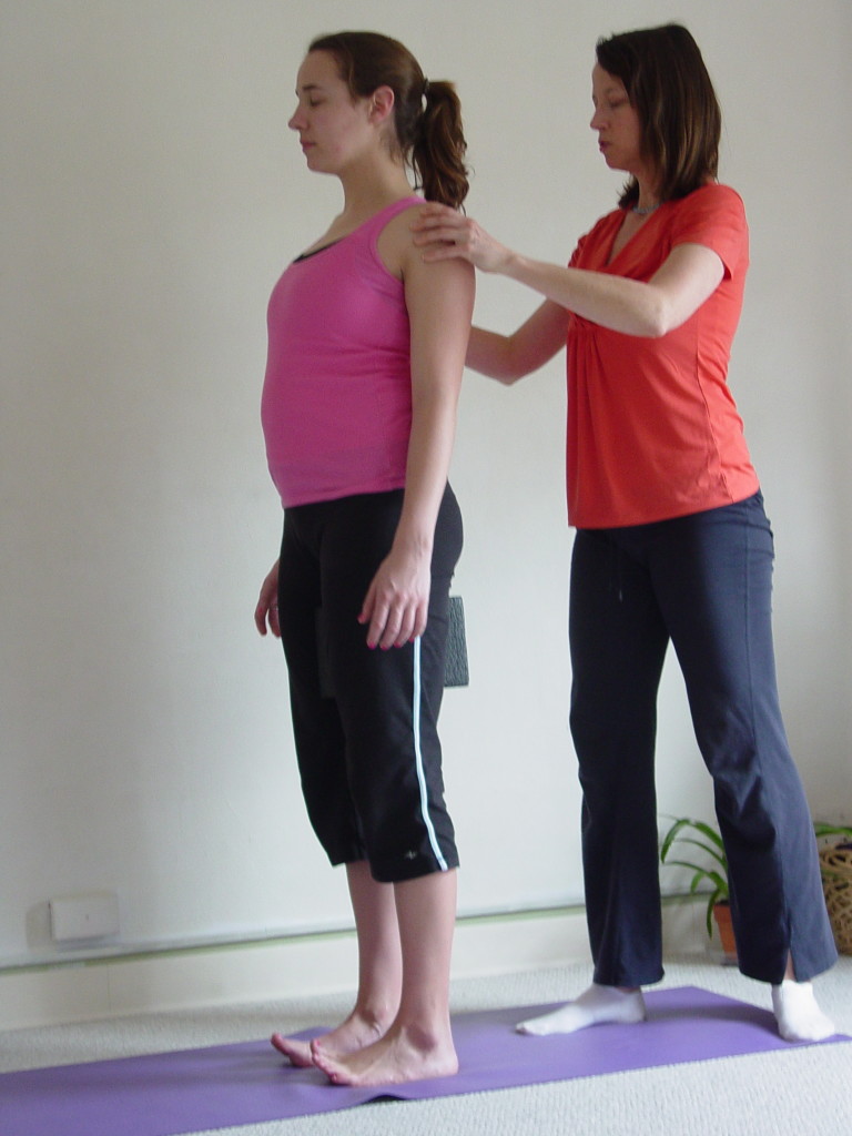 Beginning with the template of Tadasana.  We align the posture of the body with a block between the inner thighs and lift all ten toes up. This creates strong internal rotation in the lower half of the body. Imagine yourself compared to a huge oak tree, pressing down into strong roots deep into the earth. In this pose, the partner is further stabilized, grounded and supported by feeling the base of the shoulder blades pull in together.  This activates the Rhomboid Muscles, nicknamed the "liver of all muscles" and creates a strong external rotation for the upper back.